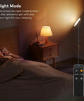 Game-Changing LED Floor Lamp With Remote Control in Night Mode beside a sleeping person in a bedroom setting.