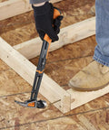 Person using IsoCore 22 Oz Milled-Face Framing Claw Hammer With Shock Reduction Dual-Layer Grip on wooden frame