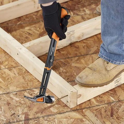 Person using IsoCore 22 Oz Milled-Face Framing Claw Hammer With Shock Reduction Dual-Layer Grip on wooden frame