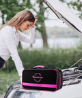 Woman examining car engine next to a pink emergency kit bag labeled 'Bhuiuyer'. Kit includes roadside rescue gear.
