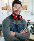 Male worker wearing Heavy Duty 72 Pack Safety Glasses With Side Shields And Rock Solid Ansi Z87 Plus Certification for protection.