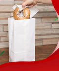 4Lb White Paper Bags Pack Of 150 Count For Lunches Cookies Holidays And Arts And Crafts Eco Friendly White Kraft Bags Great For Snack Bags And Gift Wrapping with bagel being placed inside