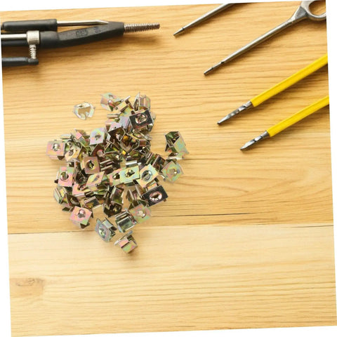 50Pcs Gold Iron Captive Nut U-Clip Fasteners for Car Bumper Grill and License Plate Mounting on wooden surface.