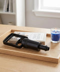 Universal Replacement Manual Cupping Pump With Ergonomic Grip For Vacuum Cups on wooden tray next to book and blue candle