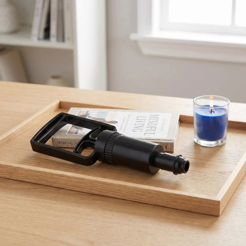 Universal Replacement Manual Cupping Pump With Ergonomic Grip For Vacuum Cups on wooden tray next to book and blue candle