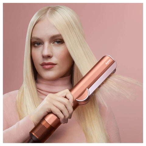 Airstrait Wet To Dry Hair Straightener With No Heat Damage in use on blonde hair for smooth frizz-free finish, rose gold color.