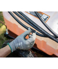 Hand adjusting hose connection on Tow-Behind Garden Sprayer With 15 Gallon Tank, 30 Inch Boom, 1.6 GPM At 100 PSI, 23 Inch Spray Wand