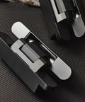 Three Pack Heavy Duty Solid Brass Invisible Hydraulic Door Hinges That Soft Close Like Butter And Require Zero Sweat Mortise Setup For Stealthy Matte Black 180 Degree Swings on textured surface.