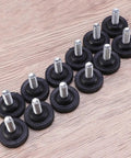 Badass Heavy Duty Adjustable Furniture Levelers With Tee Nuts Kits Black Steel And Rubber Pads For Killing Wobble On Cabinets Tables Chairs Workbenches Quick Setup - set of 12 levelers on a wood surface.