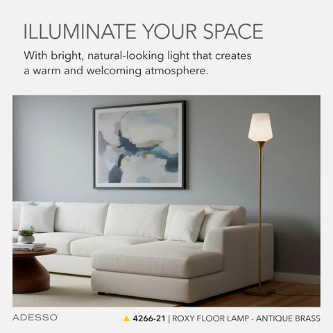 Living room with Roxy Tall Floor Lamp in Brushed Steel with White Opal Glass, 71 Inch Height beside white sofa.