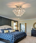 Crystal Chandelier Ceiling Light Semi Flush Mount With E26 Base In Silver Chrome Finish illuminating a cozy bedroom.