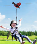 Child enjoying Epic Backyard Zipline Kit For Kids 120Ft With Tree Protectors And Trolley Safe Braking System in a park