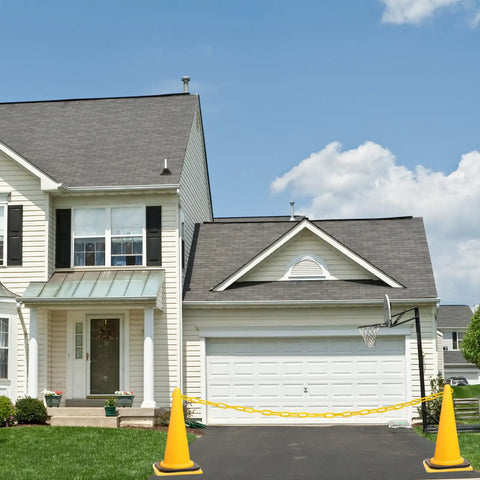 200 Ft Yellow Plastic Chain Barrier for Crowd Control and Event Decor in driveway with orange cones, weatherproof
