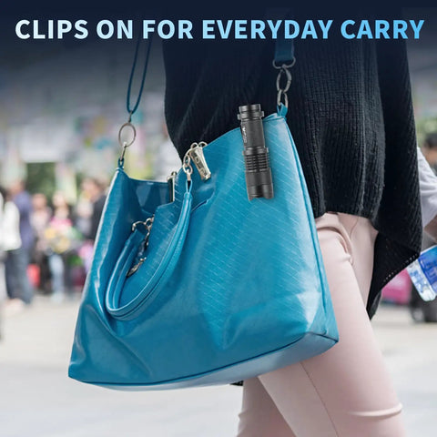 5 Pack SK68 Tactical Flashlights clipped to blue handbag, highlighting everyday carry feature.