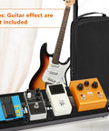 Ultra Portable Mini Guitar Pedal Board Kit With Aluminum Alloy Black Finish 15 By 5.7 By 1.18 Inches Includes Four Six Inch Patch Cables Carrying Bag Adhesive Hook Side Tape And Cable Ties For Easy Gig Setup displaying pedals and guitar backdrop