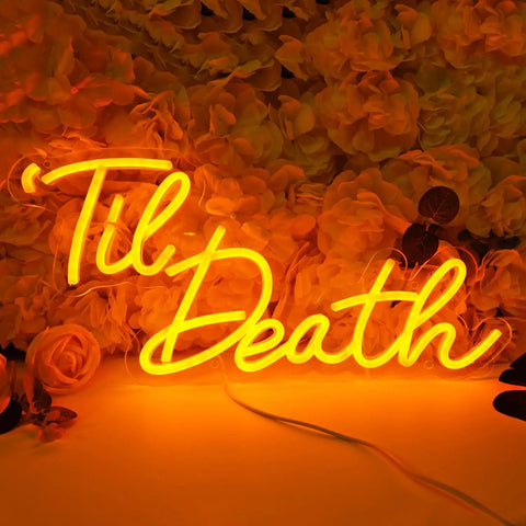 Til Death Neon Light Sign USB Powered LED Decor For Halloween Weddings Parties And Bridal Showers 17 Inch Orange Bedroom Wall Decor With On Off Switch 5V Dope Vibe glowing against flowers.