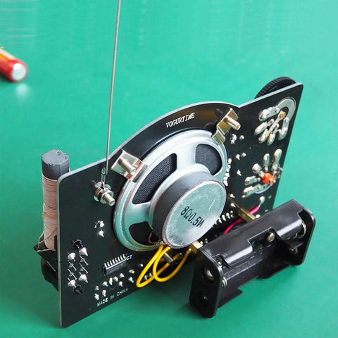 AM FM Radio Kit For Learning And Practice A Hands On Soldering Project That Teaches Electronics with exposed circuit board and speaker