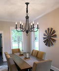 Six Light Black Farmhouse Chandelier With Industrial Modern Vibe Candle Style Hanging Light Fixture in dining room setting