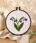 Embroidery Starter Kit With Cotton Threads Three Skeins Punch Needle Hoop Stencils And Heat Erasable Pen For Modern Floral Design Beginners Ideal For DIY Crafters Looking To Level Up Their Floral Embroidery Projects on white fabric with purple flowers