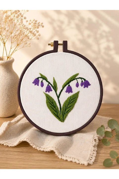 Embroidery Starter Kit With Cotton Threads Three Skeins Punch Needle Hoop Stencils And Heat Erasable Pen For Modern Floral Design Beginners Ideal For DIY Crafters Looking To Level Up Their Floral Embroidery Projects on white fabric with purple flowers