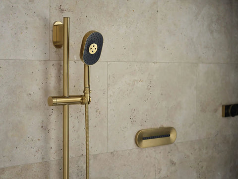 80cm slide bar with integrated water supply for handheld showers in gold finish installed on bathroom wall