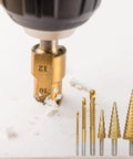 Close-up of Six Piece High Speed Reaming Pagoda Sawtooth Drill Bit Set with titanium plating in use, showing serrated bit drilling.