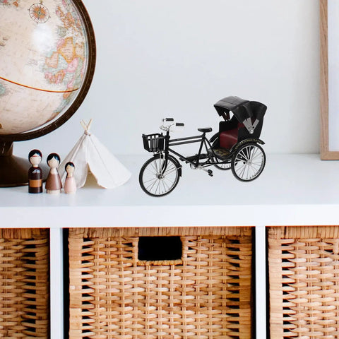 Absolutely Sweet Mini Motorcycle And Vintage Rickshaw Cake Topper With Detailed Metal Alloy Body on a shelf with a globe and decor.