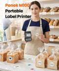 Dead Simple Wireless Bluetooth Label Printer With Tape Slick Portable Unit generates address and barcode labels, shown with bread.