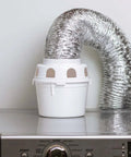 Indoor Clothes Dryer Vent Kit With 4 Inch By 5 Foot ProFlex Duct and Plastic Lint Reservoir on washing machine.
