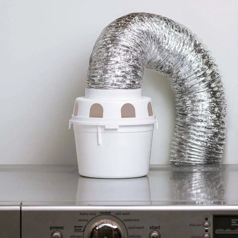 Indoor Clothes Dryer Vent Kit With 4 Inch By 5 Foot ProFlex Duct and Plastic Lint Reservoir on washing machine.