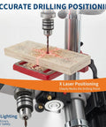 10 Inch Benchtop Drill Press With 5 Amp Variable Speed Motor And Led Light demonstrating laser positioning on wood.