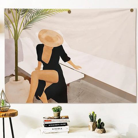 Artistic wall decor featuring a woman in a black dress and a hat, seated beside a plant and minimalist furniture.
