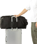 60L Heavy Duty Duffel Travel Bag With Waterproof 900D Exterior on silver suitcase