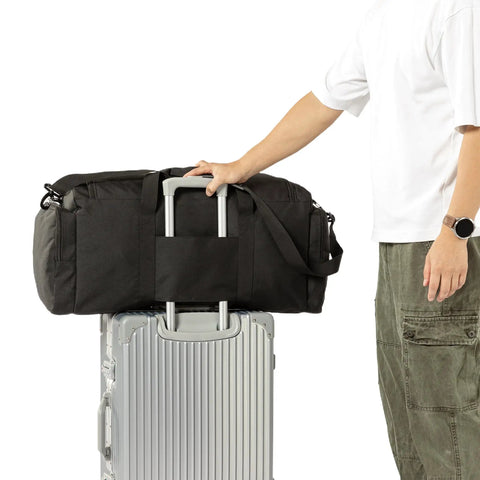 60L Heavy Duty Duffel Travel Bag With Waterproof 900D Exterior on silver suitcase
