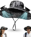 Wide Brim Solar Fan Hat With Built-In Cooling, UPF Fifty Plus Sun Protection, Bucket Style, Gray Camo worn by man and woman