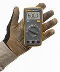 Palm Sized Digital Multimeter Handy And Snappy For Voltage And Current Readings With Resistance Continuity And Capacitance Tests 10 Amp AC And DC Current Measurement Data Hold One Hand Operation India Version held in gloved hand