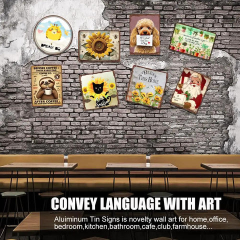 Variety of novelty aluminum tin signs displayed on a textured brick wall above a wooden table setting.