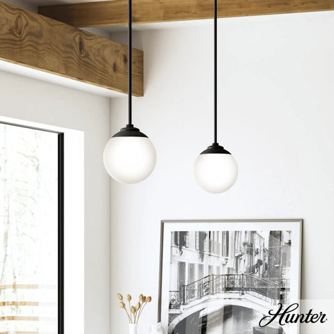 Hepburn 1-Light Modern Brass Pendant Light With Globe Shaped White Glass Shade, Dimmable, hanging in a bright room
