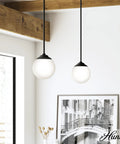 Hepburn 1 Light Brushed Nickel Pendant Light Dimmable Globe Shape Small Sleek Modern Style Fixture in a living room setting