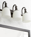 Three Light Bathroom Vanity Light In Oiled Bronze With Clear Seeded Glass From The Richmond Collection Modern Transitional Style LED Compatible And Damp Rated For Bathrooms Perfect For Contemporary Master Bath Or Powder Room. Oiled bronze finish above bathroom mirror with three lights.