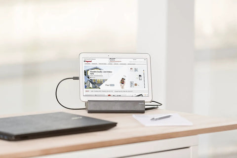 Kickstart Your Workspace Game With This Solid Three Outlet Power Strip And Dual Usb Charging Station Features Sturdy Tablet Cradle with tablet and laptop on a desk.