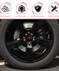 Four Pack Car Wheel Center Hub Caps With Metallic Skull Badge on black truck wheel, showing red skull design and metal finish.