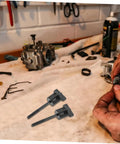 Spare Tire Hold Down Screw With Durable Tire Anchor, Easy Tool Install, shown on a garage workbench with automotive tools