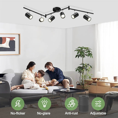 Six Light Black Track Lighting Kit With Adjustable LED Heads And GU10 Sockets in modern living room setting, illuminating art wall.