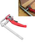 Heavy Duty Ratcheting Table Clamp Hardcore Rail Fixture For Woodworking and Rock Solid Material Stabilization Built With Premium Chrome Steel For Pro Shops in use, showing jaw clamp on wood.