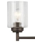 Close-up of Four Light Vanity Light in Olde Bronze with clear seeded glass, transitional style, for above bathroom mirror.