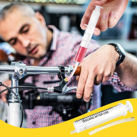 Using Brake Bleed Kit For Shimano Hydraulic Brakes With Mineral Oil 120ml on bike handlebar in workshop setting