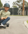 Child riding Ground Force Rad Rod Pocket Go Kart For Kids Six And Up With Ten MPH Top Speed And Forty Minute Run Time on pavement.