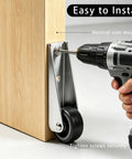 Installation of Heavy Duty Gate Caster Wheels 4 Pack Replacement Roller Wheels on wood surface with drill tool.