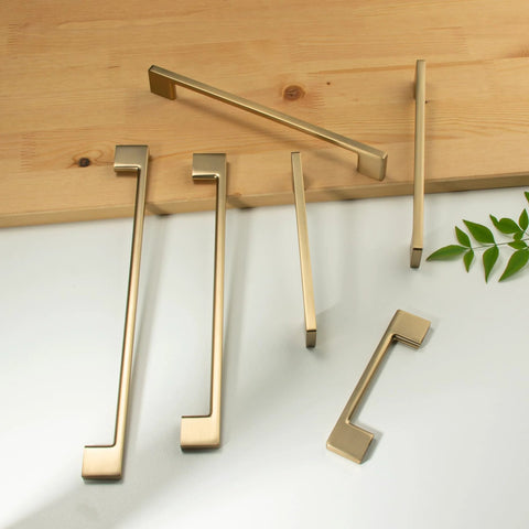 Classic 10 Pack Cabinet Pull Handles for Kitchen and Bedroom Cabinets in Champagne Bronze Finish, displayed on a table, 5 Inch Center To Center Screw Spacing, Solid Zinc Alloy Construction, Easy To Install.
